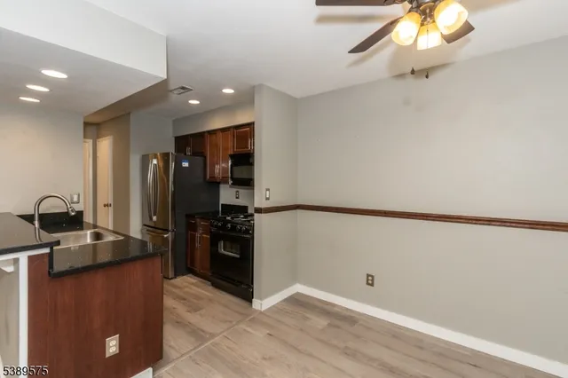 a kitchen with a refrigerator and a sink
