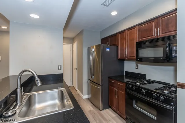 a kitchen with a sink a stove and refrigerator