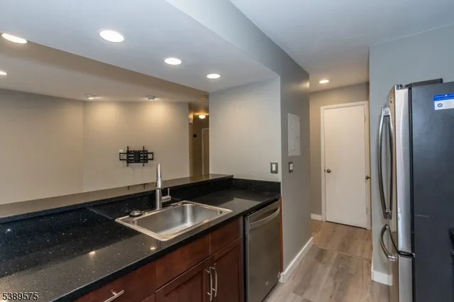 a kitchen with a sink and a refrigerator