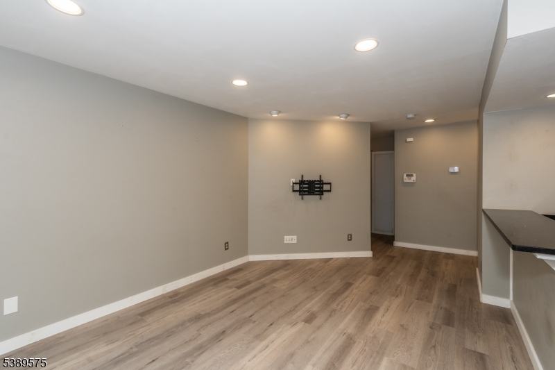 32 Sam Bonnell Drive Clinton, NJ 08809 - Photo 5 of 30 an empty room with wooden floor and windows