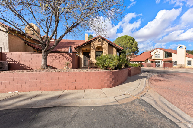 301 South 1200th Street East, Unit 31 St. George, UT 84790 - Photo 3 of 21 Mediterranean / spanish home with a fenced front yard, a chimney, stucco siding, and a tile roof