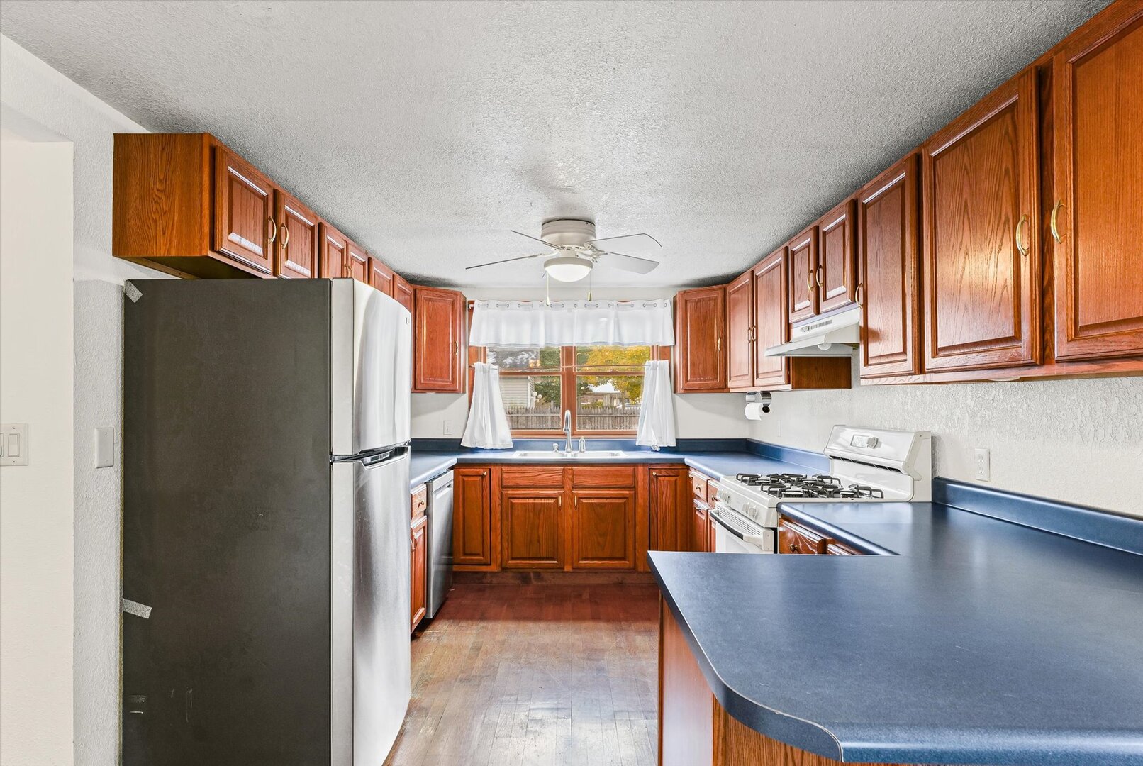 501 East McClelland Street Monticello, IL 61856 - Photo 11 of 31 a kitchen with stainless steel appliances granite countertop a refrigerator a stove and a sink