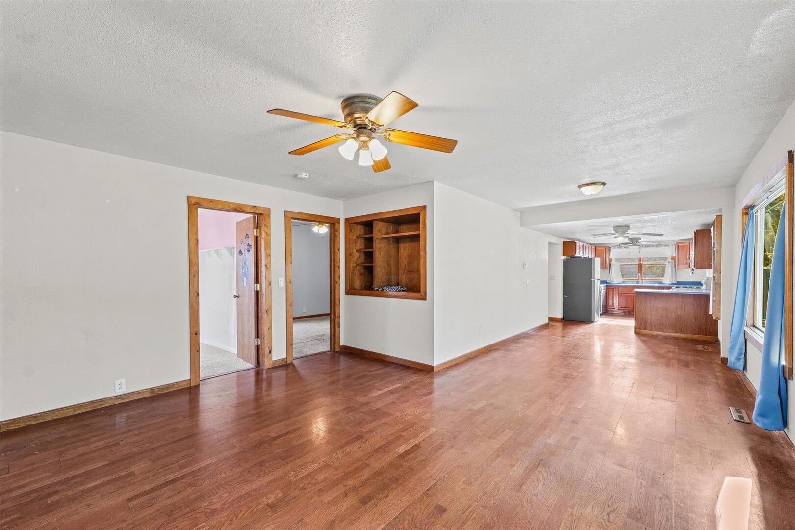 501 East McClelland Street Monticello, IL 61856 - Photo 7 of 31 a view of a big room with wooden floor and windows