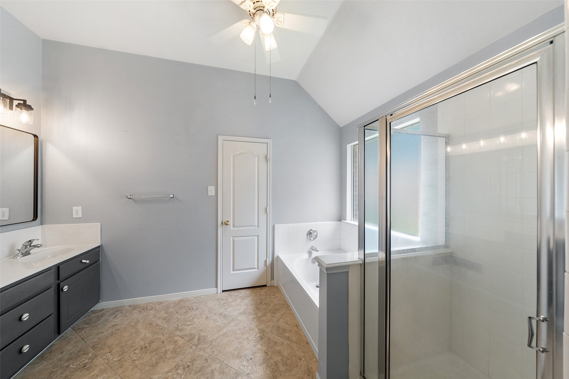 19718 Teller Boulevard Spring, TX 77388 - Photo 22 of 47 a spacious bathroom with a double vanity sink a mirror and a shower