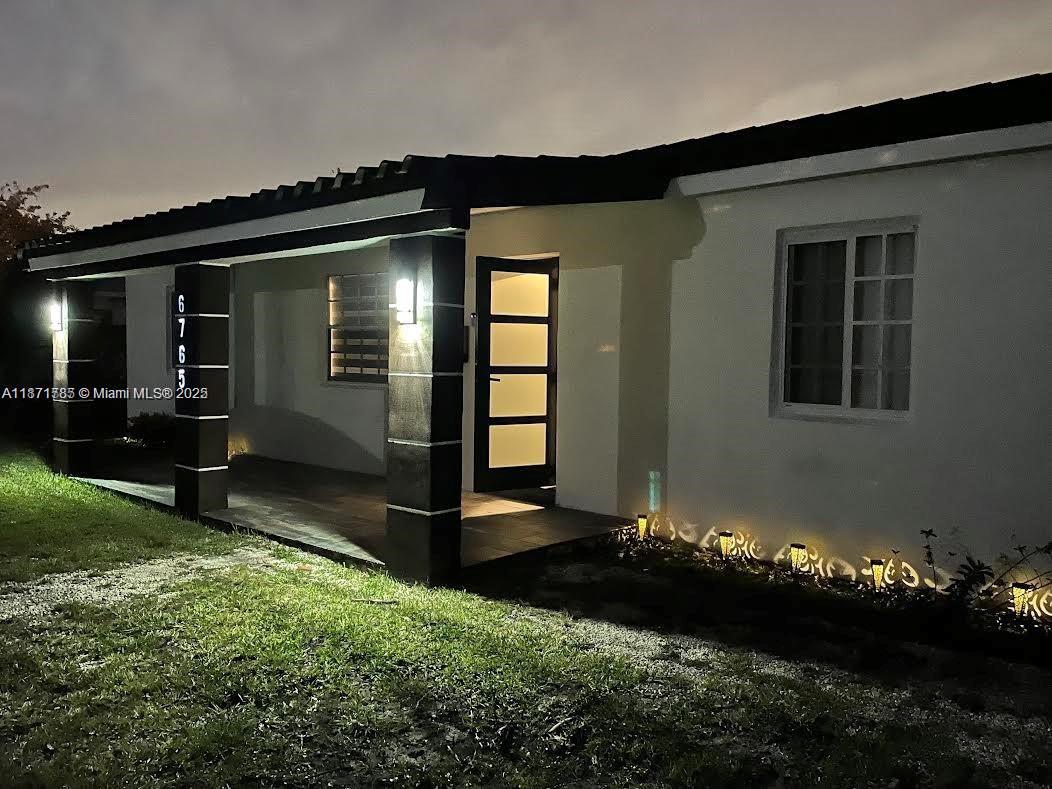 6765 Southwest 17th Street, Unit 6765 Miami, FL 33155 - Photo 1 of 9 a backyard of a house with lots of green space and outdoor seating