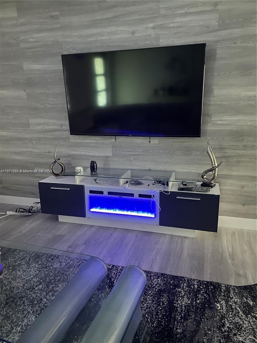 6765 Southwest 17th Street, Unit 6765 Miami, FL 33155 - Photo 3 of 9 a living room with stainless steel appliances kitchen island granite countertop a sink and a microwave