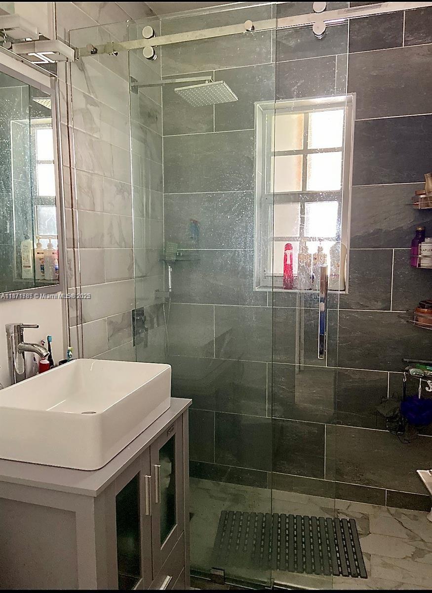 6765 Southwest 17th Street, Unit 6765 Miami, FL 33155 - Photo 4 of 9 a bathroom with a sink and a shower
