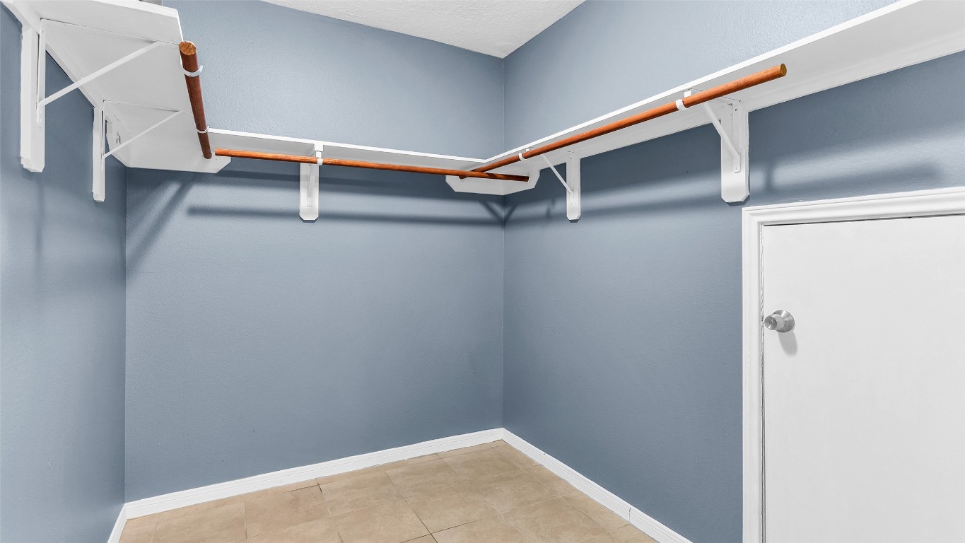 5534 Calm Court Houston, TX 77084 - Photo 23 of 48 A large primary walk-in closet offers ample storage and convenience.