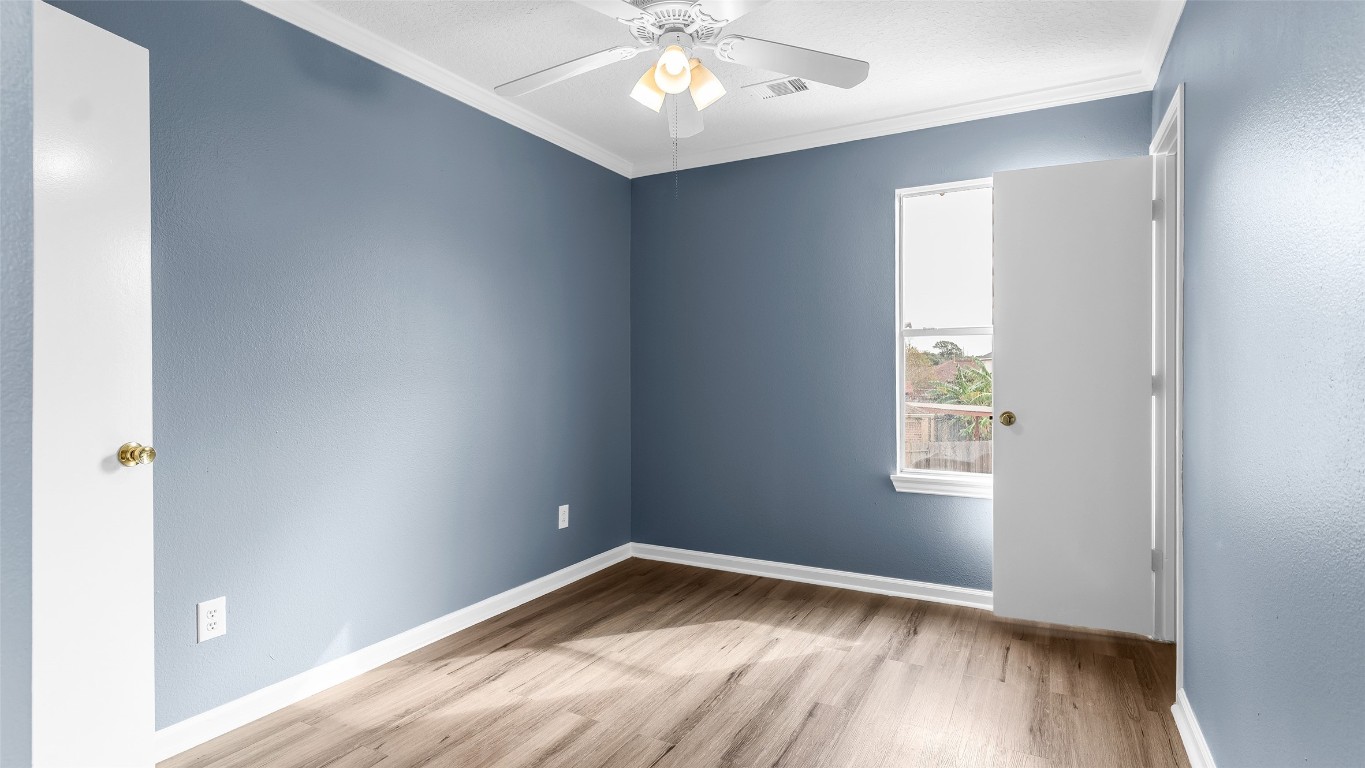 5534 Calm Court Houston, TX 77084 - Photo 25 of 48 an empty room with wooden floor and windows