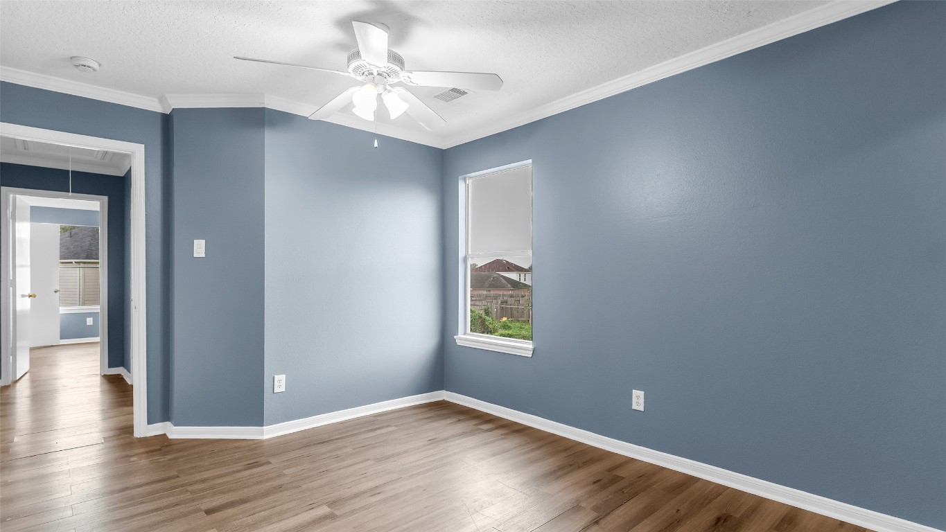 5534 Calm Court Houston, TX 77084 - Photo 28 of 48 an empty room with wooden floor and windows