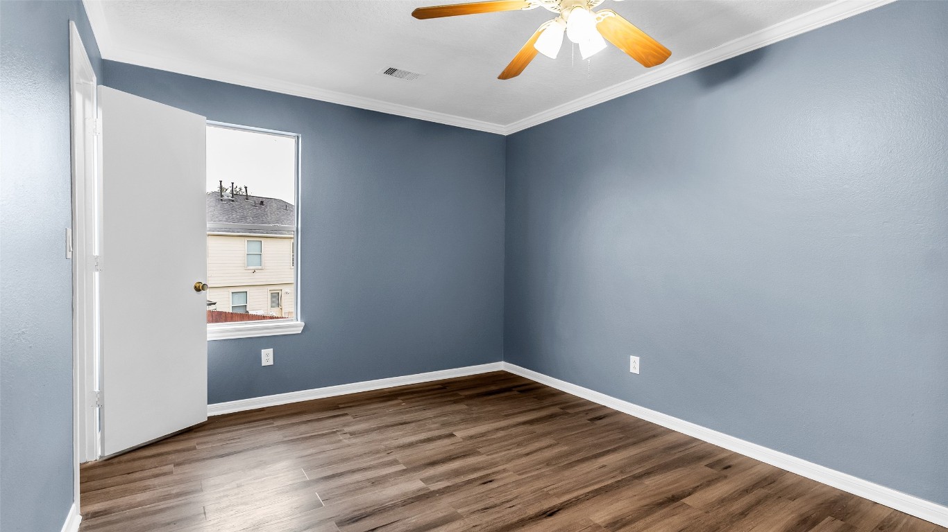 5534 Calm Court Houston, TX 77084 - Photo 30 of 48 an empty room with wooden floor and windows