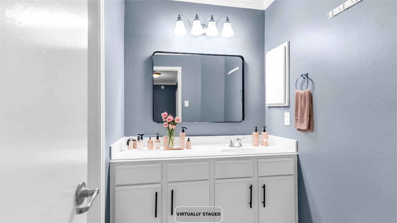 5534 Calm Court Houston, TX 77084 - Photo 32 of 48 a bathroom with a double vanity sink and a mirror