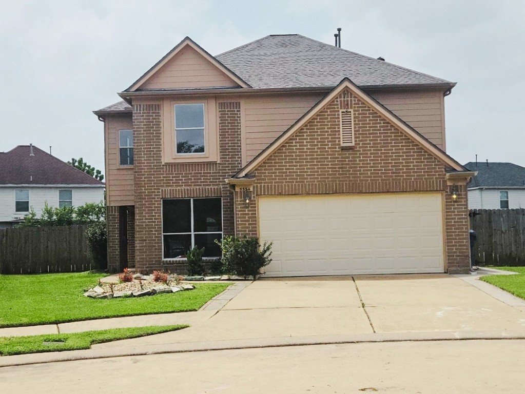 5534 Calm Court Houston, TX 77084 - Photo 48 of 48 a front view of a house with a yard and garage