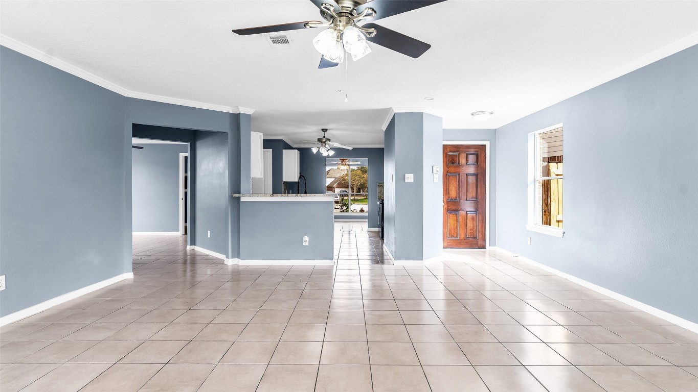 5534 Calm Court Houston, TX 77084 - Photo 5 of 48 a view of a livingroom with a chandelier fan and windows