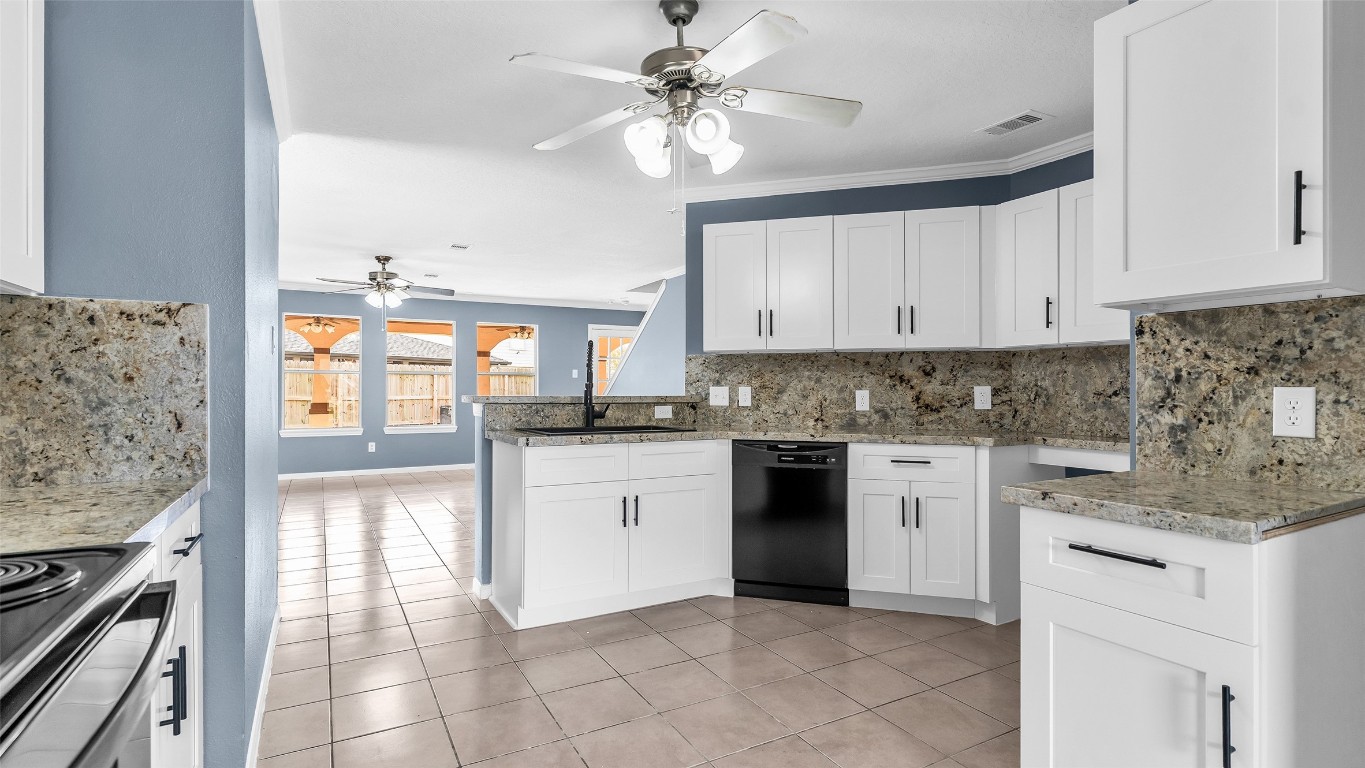 5534 Calm Court Houston, TX 77084 - Photo 7 of 48 a kitchen with granite countertop a stove a sink and a refrigerator