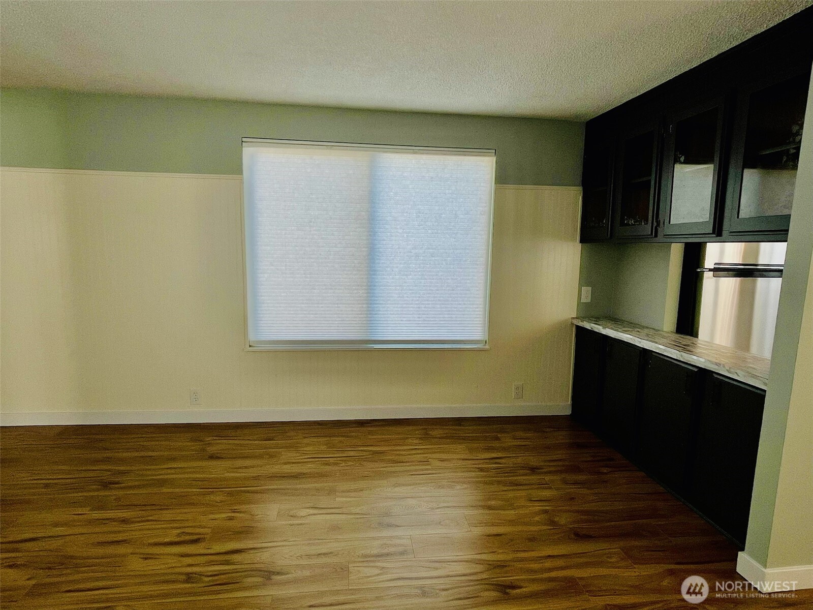 545 Hendricks Street, Unit 13 Port Townsend, WA 98368 - Photo 13 of 22 a view of an empty room with wooden floor and a fireplace