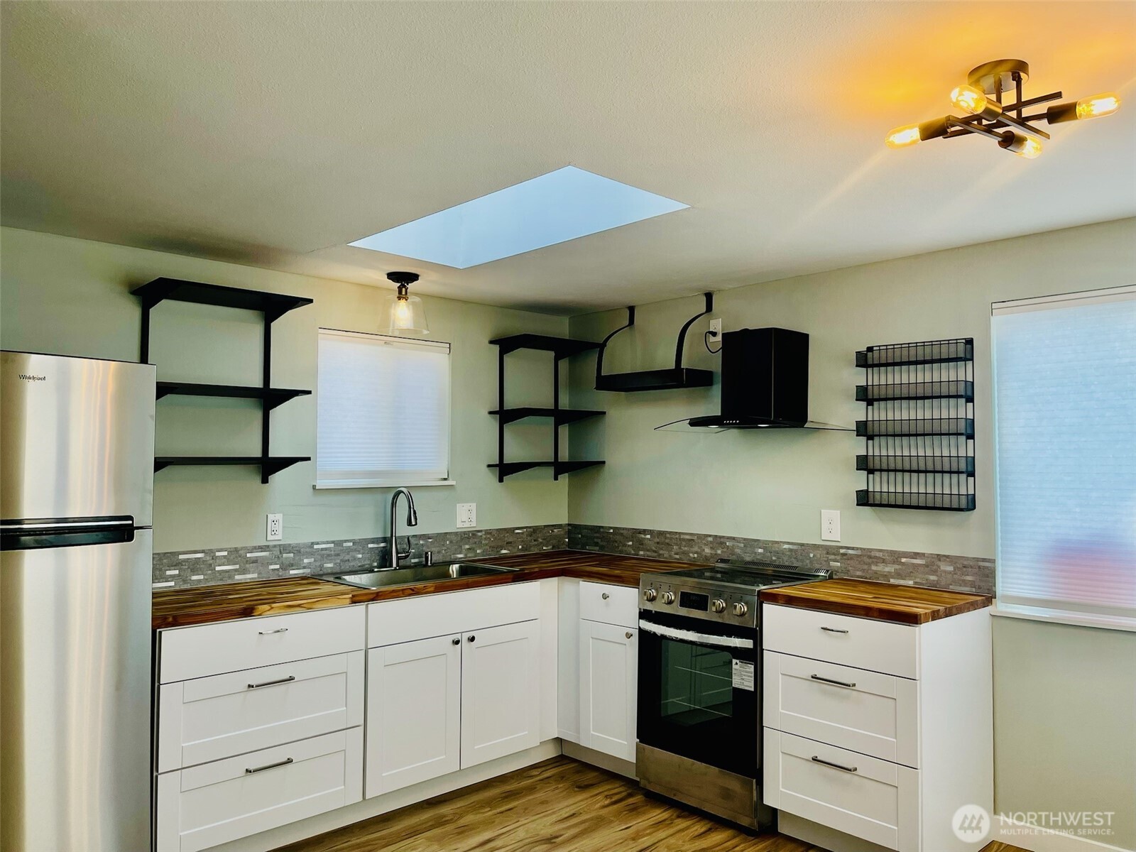 545 Hendricks Street, Unit 13 Port Townsend, WA 98368 - Photo 5 of 22 a kitchen with stainless steel appliances granite countertop a stove and a sink