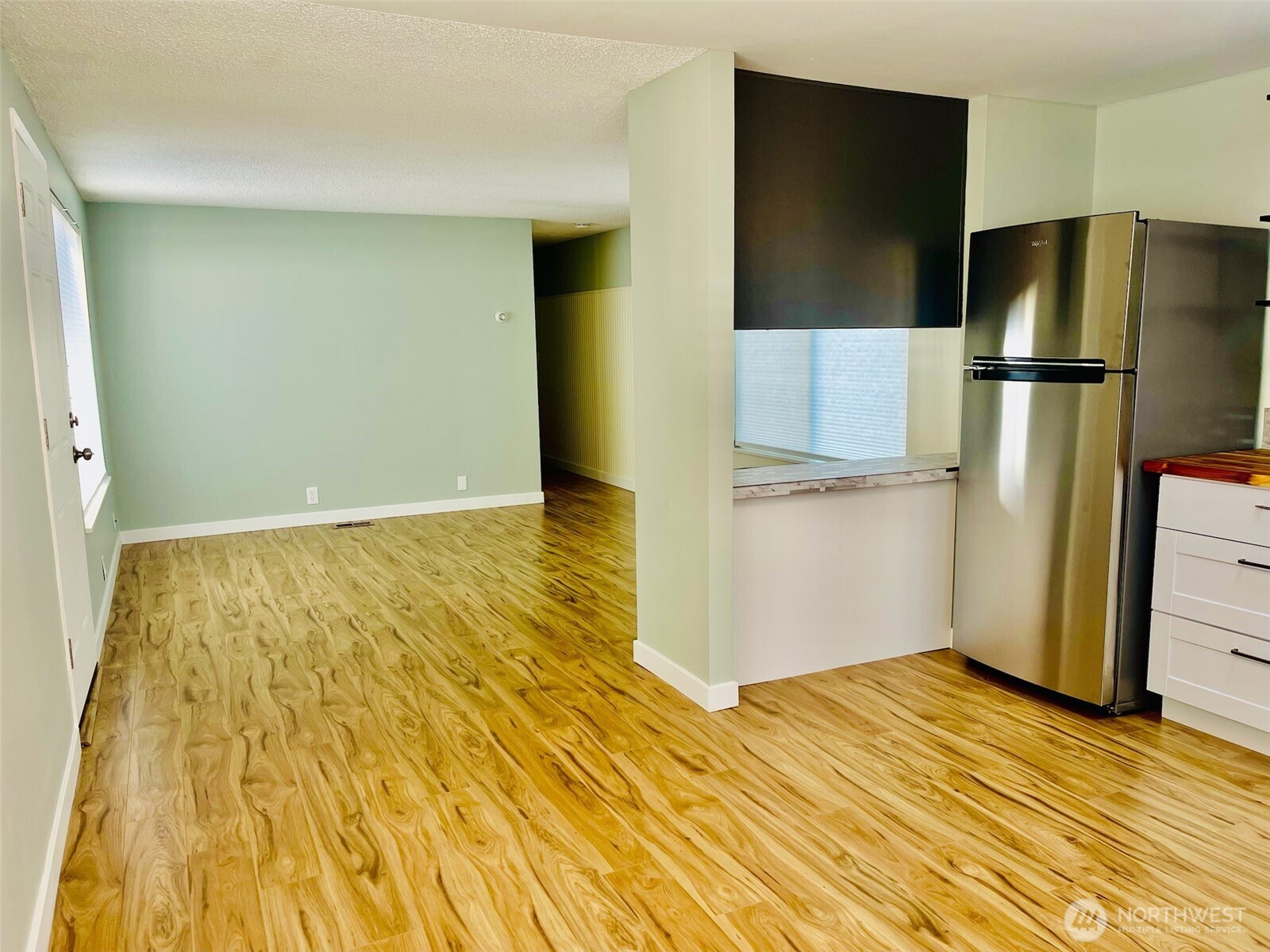 545 Hendricks Street, Unit 13 Port Townsend, WA 98368 - Photo 7 of 22 a view of a kitchen with a sink and refrigerator