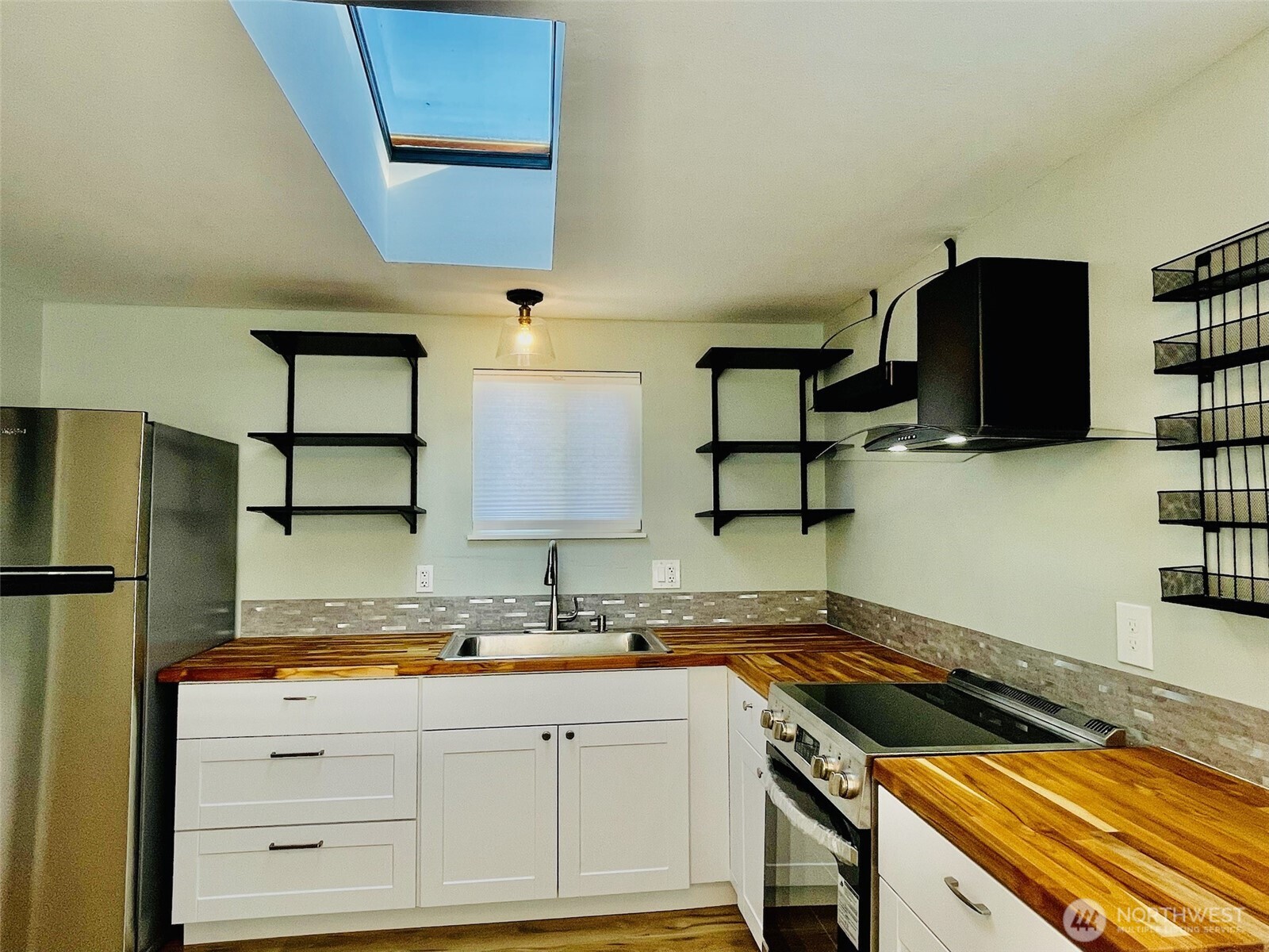 545 Hendricks Street, Unit 13 Port Townsend, WA 98368 - Photo 8 of 22 a kitchen with granite countertop a sink a stove and a refrigerator