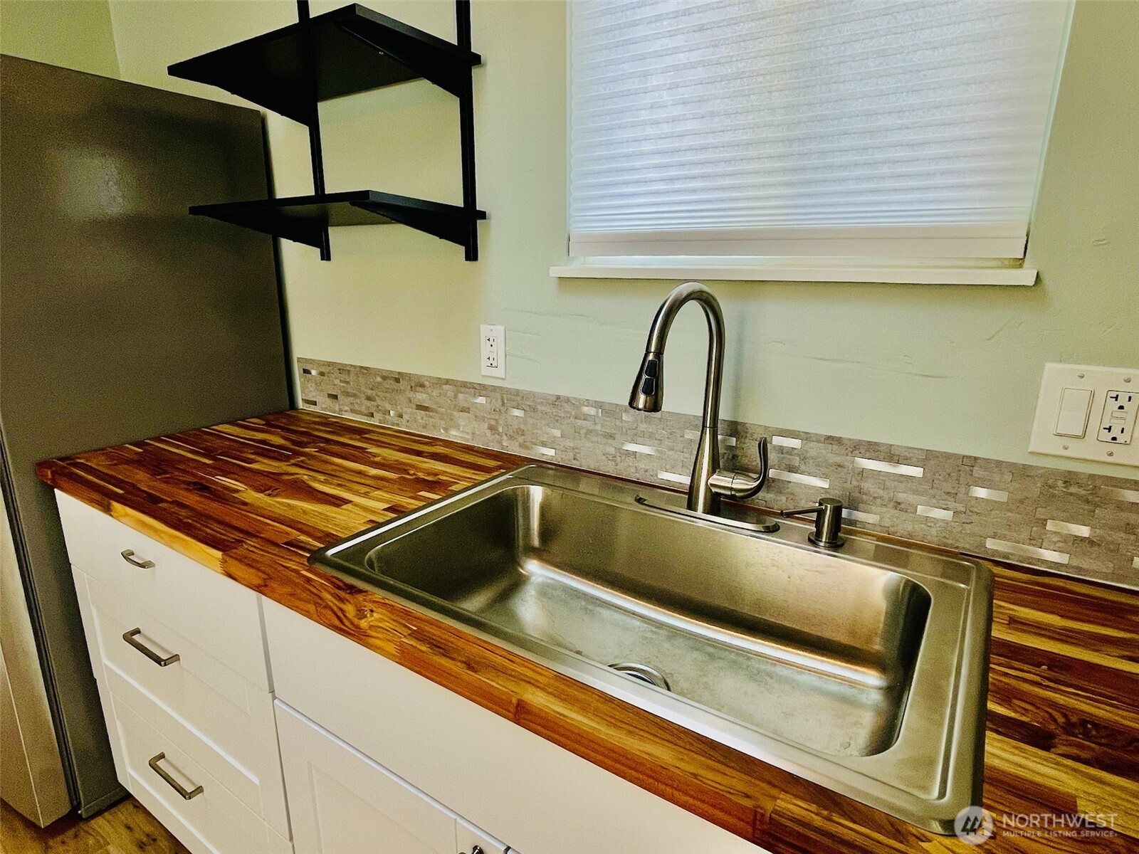 545 Hendricks Street, Unit 13 Port Townsend, WA 98368 - Photo 9 of 22 a close view of a sink a counter and appliances in the kitchen