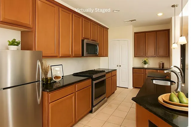 a kitchen with stainless steel appliances granite countertop a sink stove and cabinets