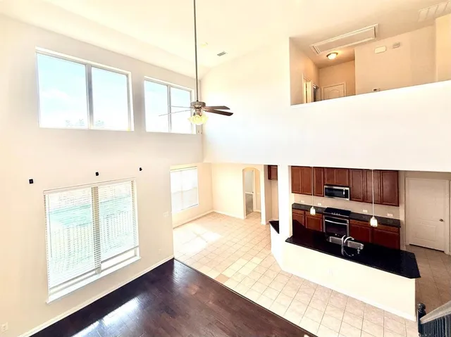 a kitchen with stainless steel appliances granite countertop a sink counter space cabinets and a large window
