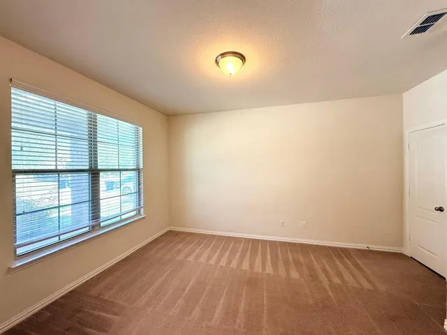 a living room with furniture and a chair