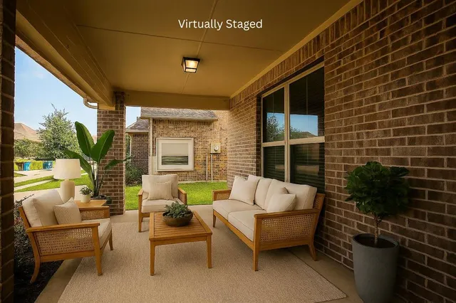 a balcony with furniture and a potted plant