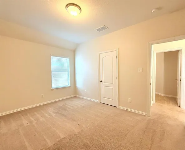 a bedroom with bed and window
