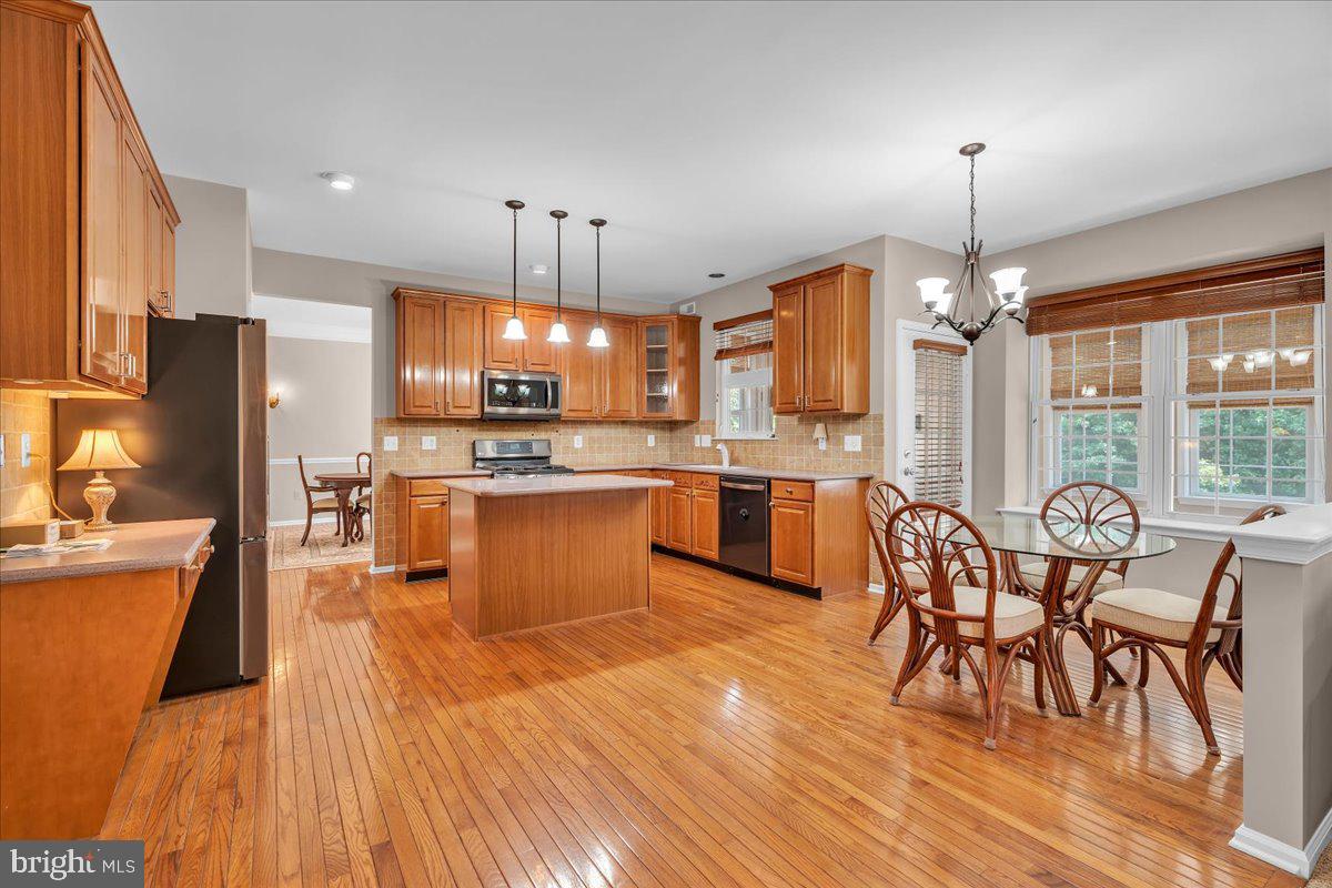 68 Hillside Lane Mount Laurel, NJ 08054 - Photo 13 of 36 a large kitchen with a table chairs refrigerator and microwave