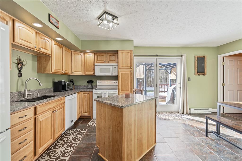 261 Casselman Road Markleton, PA 15551 - Photo 16 of 42 a kitchen with stainless steel appliances kitchen island granite countertop a refrigerator and a stove top oven
