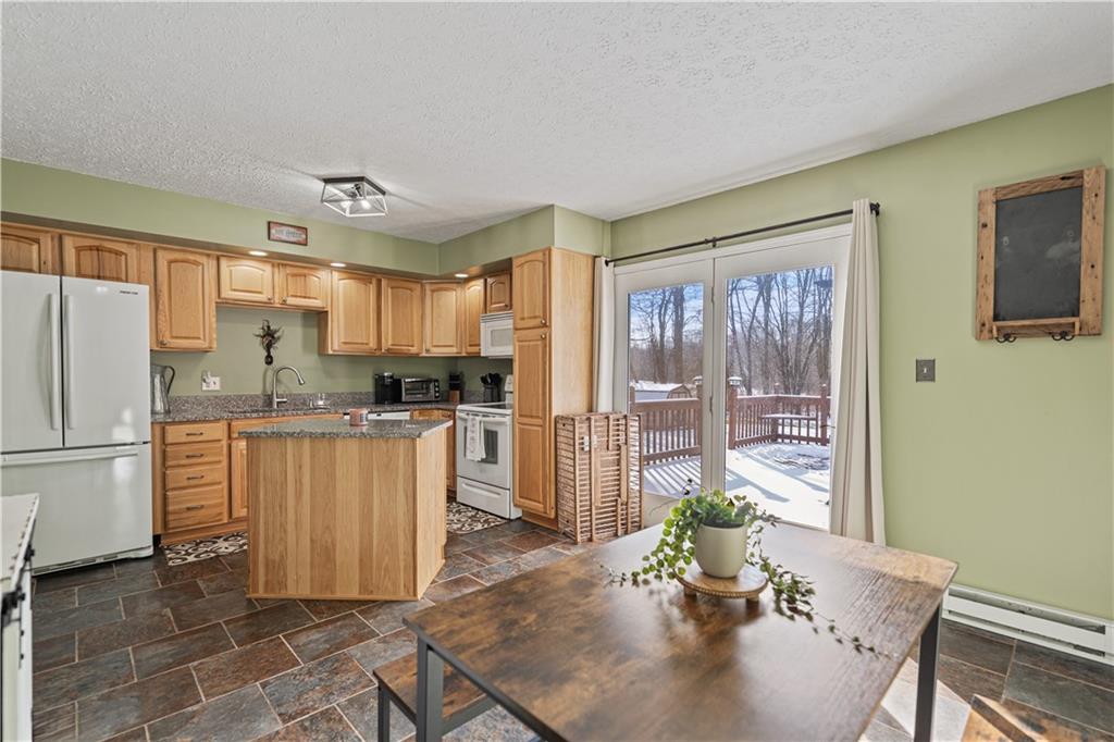 261 Casselman Road Markleton, PA 15551 - Photo 18 of 42 a kitchen with refrigerator cabinets and large window
