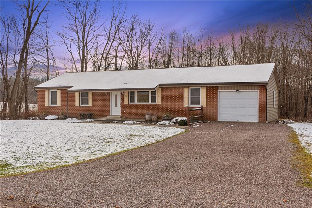 261 Casselman Road Markleton, PA 15551 - Photo 2 of 42 a front view of a house with a yard and garage