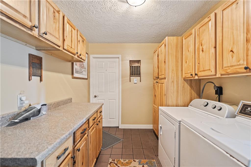 261 Casselman Road Markleton, PA 15551 - Photo 22 of 42 a utility room with a sink a washer and dryer
