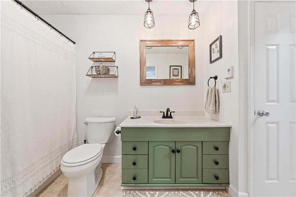261 Casselman Road Markleton, PA 15551 - Photo 28 of 42 a bathroom with a toilet sink and mirror