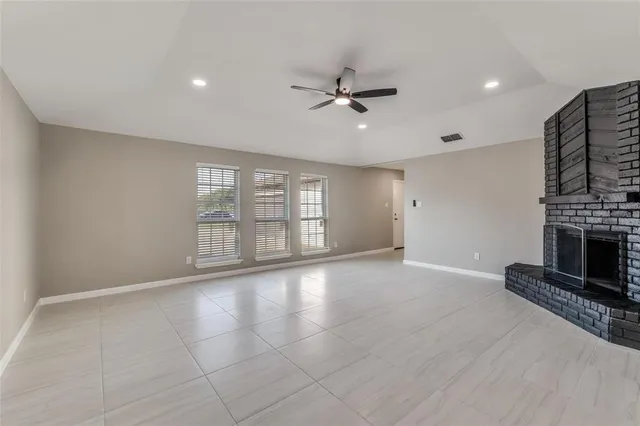 a view of an empty room with a fireplace