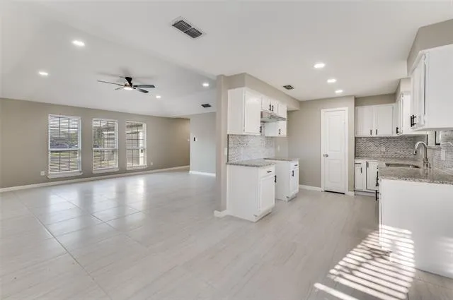 a view of kitchen with stainless steel appliances refrigerator oven and cabinets