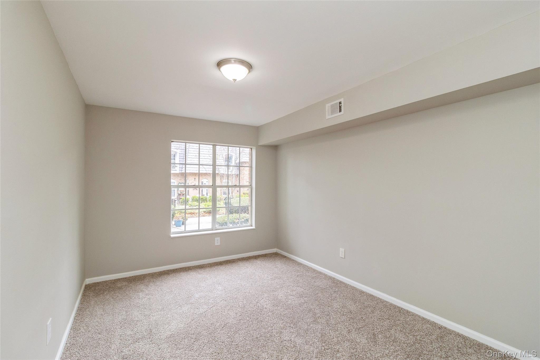 655 Middle Country Road, Unit 4D1 Coram, NY 11727 - Photo 17 of 27 an empty room with a window