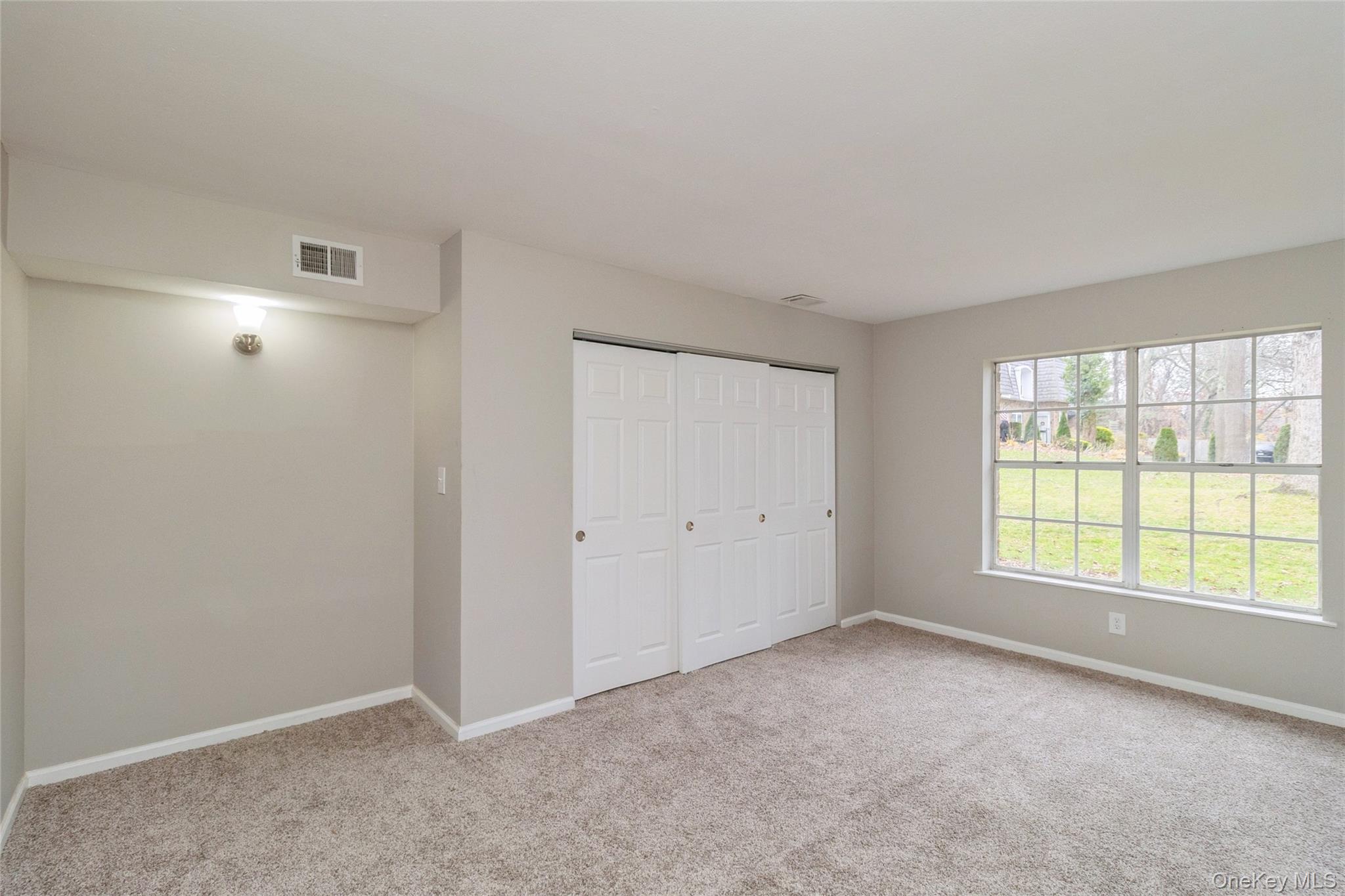 655 Middle Country Road, Unit 4D1 Coram, NY 11727 - Photo 20 of 27 a view of an empty room with a window