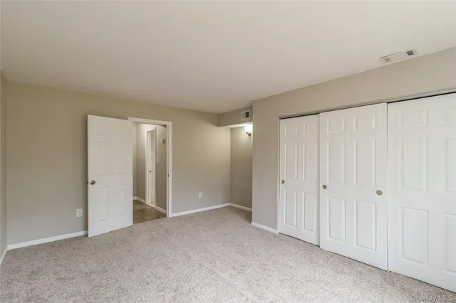 a bathroom with a toilet sink vanity and mirror