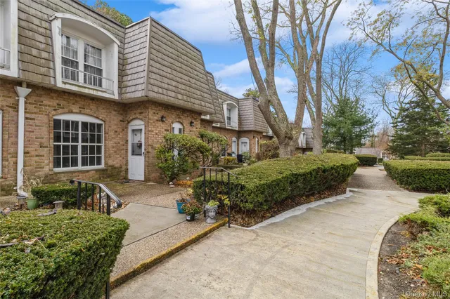 a front view of a house with a yard and outdoor seating