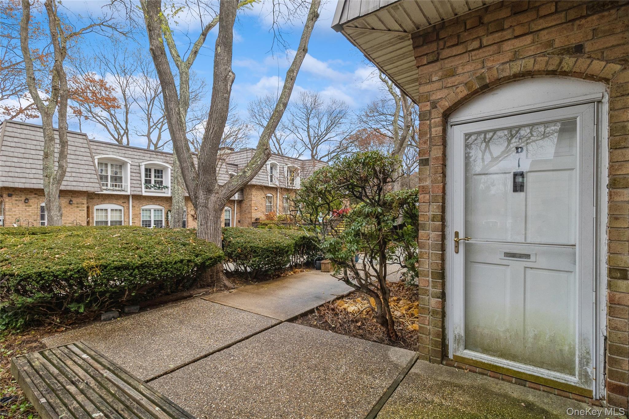 655 Middle Country Road, Unit 4D1 Coram, NY 11727 - Photo 5 of 27 a view of a brick house with a yard