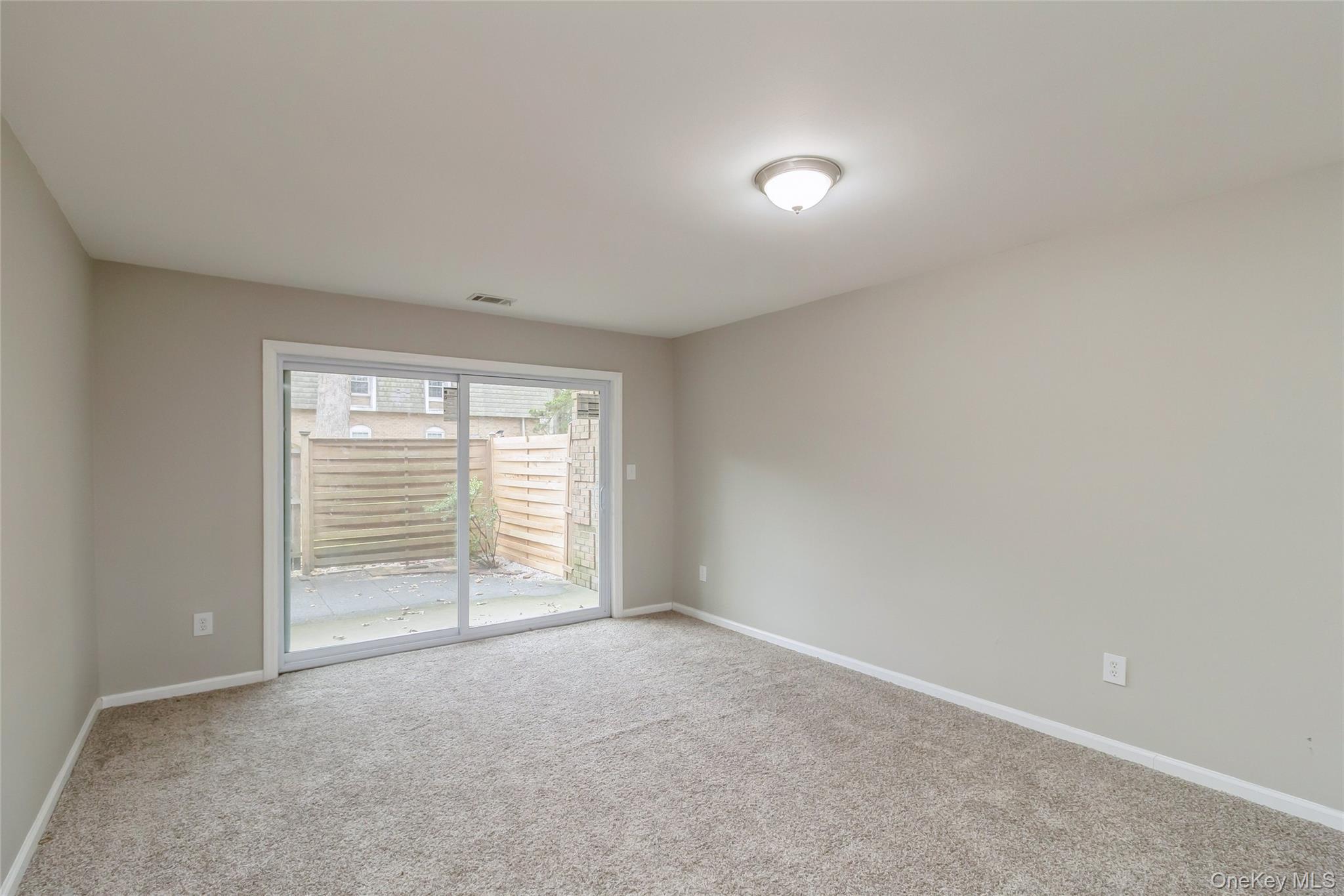 655 Middle Country Road, Unit 4D1 Coram, NY 11727 - Photo 10 of 27 a view of an empty room with a window
