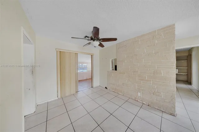 a view of an empty room and bathroom