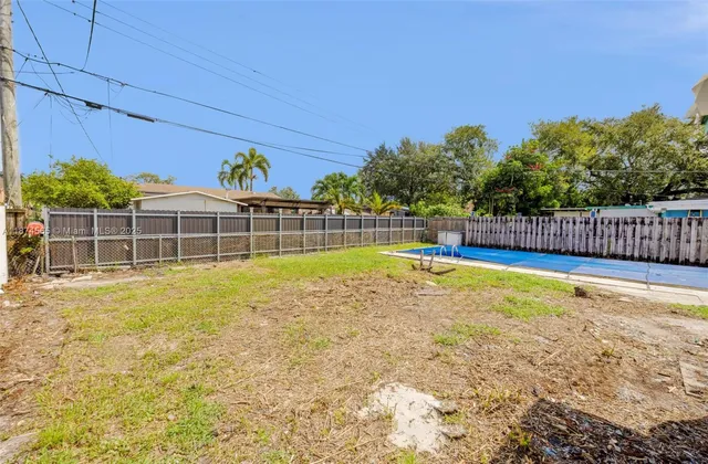 a view of a house with pool and a yard