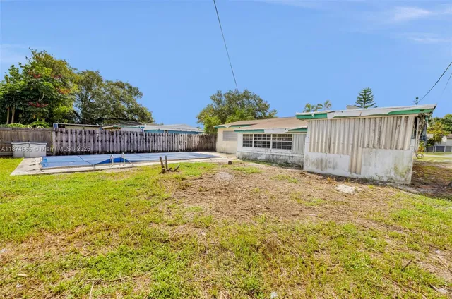 a view of a backyard with sitting area