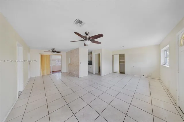 a view of a livingroom with a ceiling fan and window