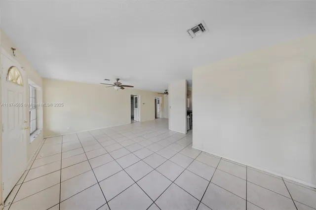 a view of a livingroom with an empty space and a window