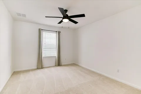 a bedroom with double bed and a window