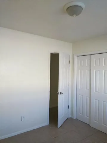 an empty room with closet area